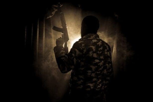 Silhouette of a man with assault gun