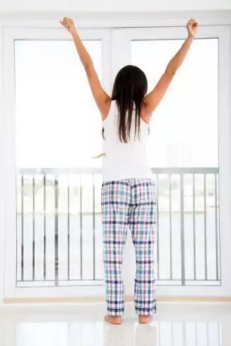 Woman stretching her arms after waking up