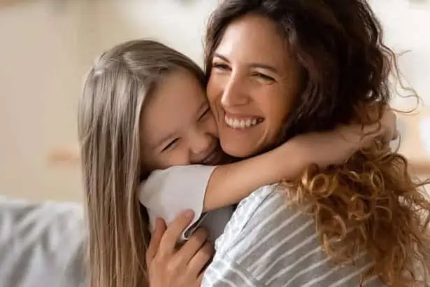 A young girl hugging her mother