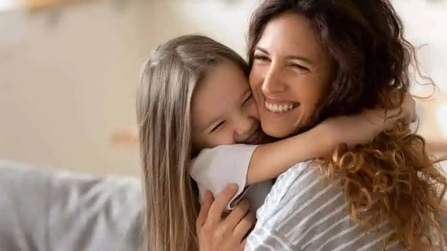 7 Struggles of Being a Single Child in India 2 A young girl hugging her mother Struggles of Being a Single Child in India