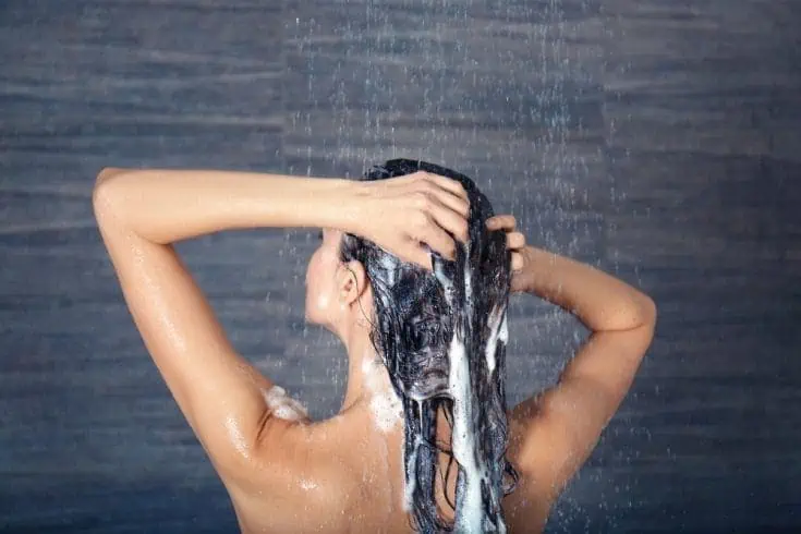Top 15 Strange Superstition in India 8 A woman washing her hair during shower