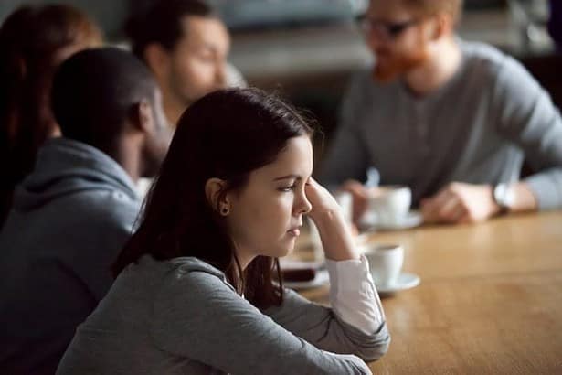 Introvert sitting quietly among people