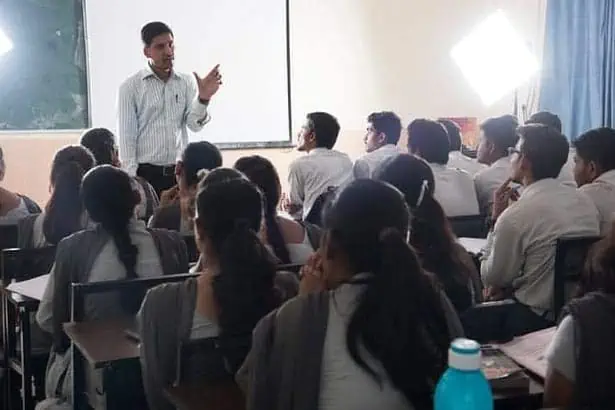 Professor teaching college students in a classroom