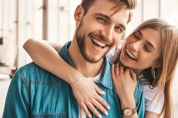 Girlfriend hugging her boyfriend from behind