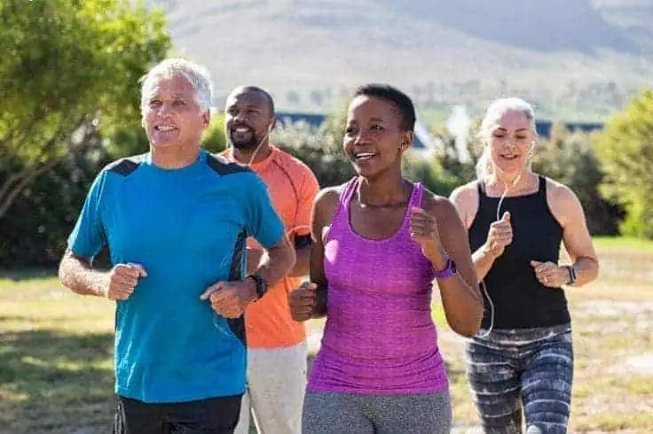 A group of senior people jogging on a bright sunny day