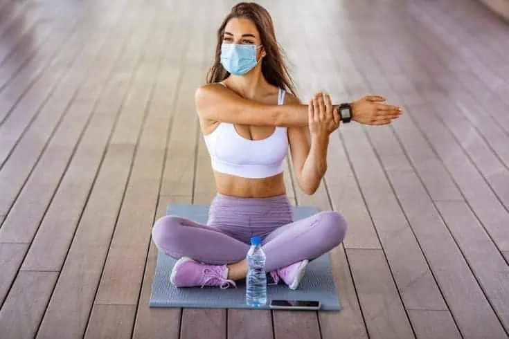 Telepathy - 6 Amazing Ways It Can Change your Life 2 Woman sitting on a yoga mat and stretching
