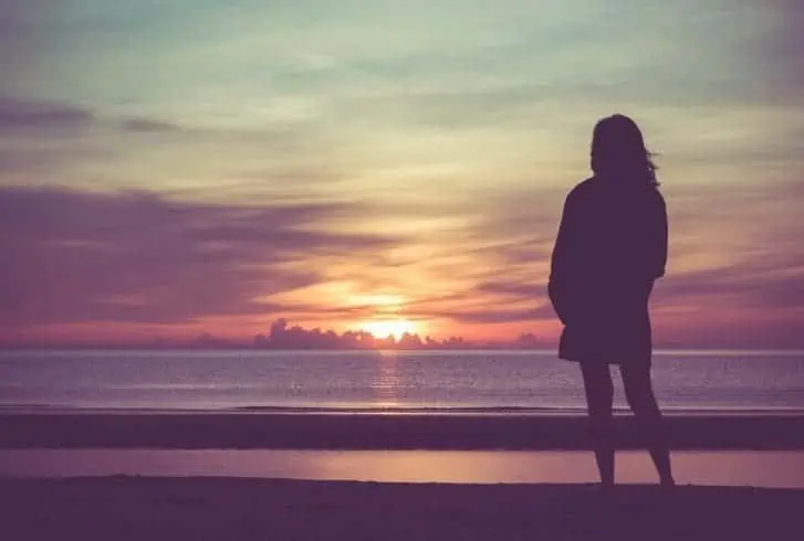 Woman standing on a beach. text