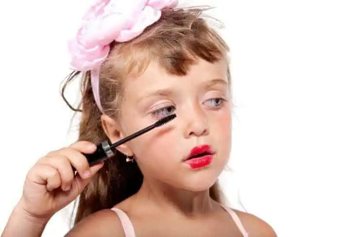 A young girl putting makeup on her face. Reality Shows