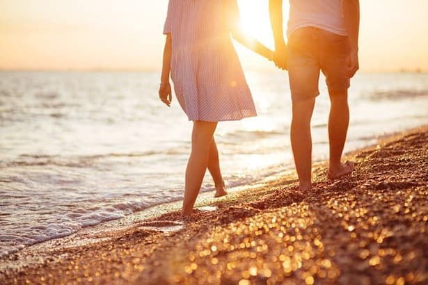 my beloved. Young couple walking on the seashore