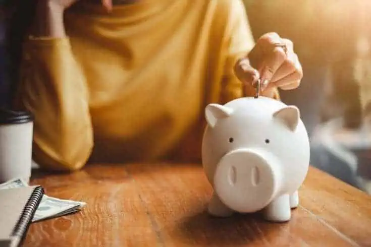 Short Girls: 12 Amazing Perks of Being Short 4 Woman adding coin in the piggy bank
