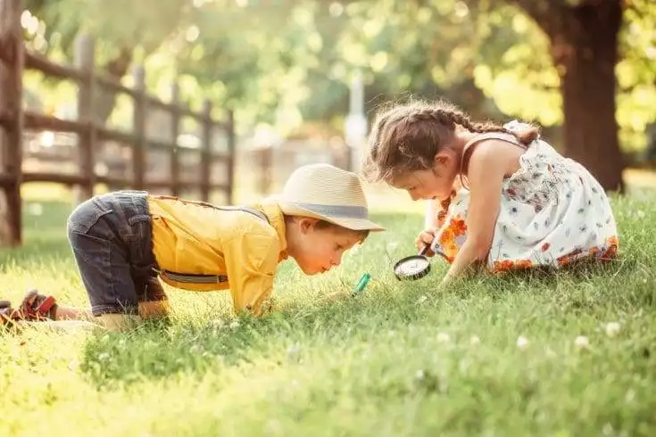A poem about life 2 A young boy and a girl curious about something on grass