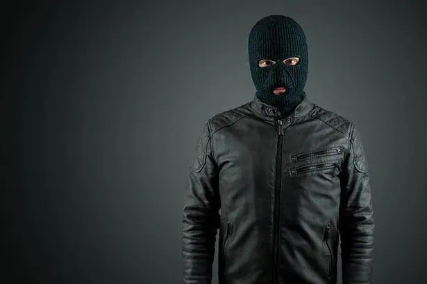 A robber wearing a black mask