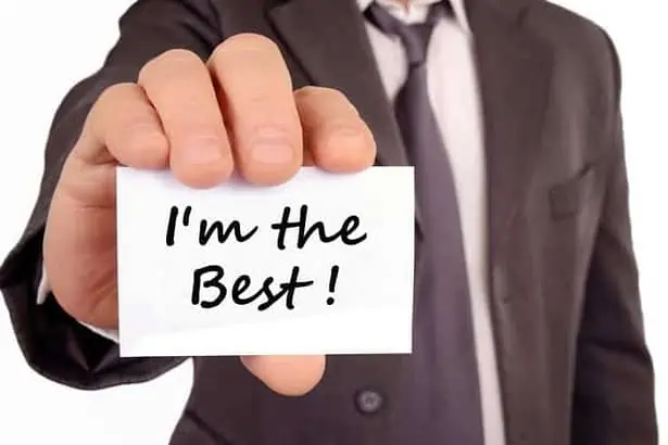 Man holding a card with I'm the best written on it. annoying people