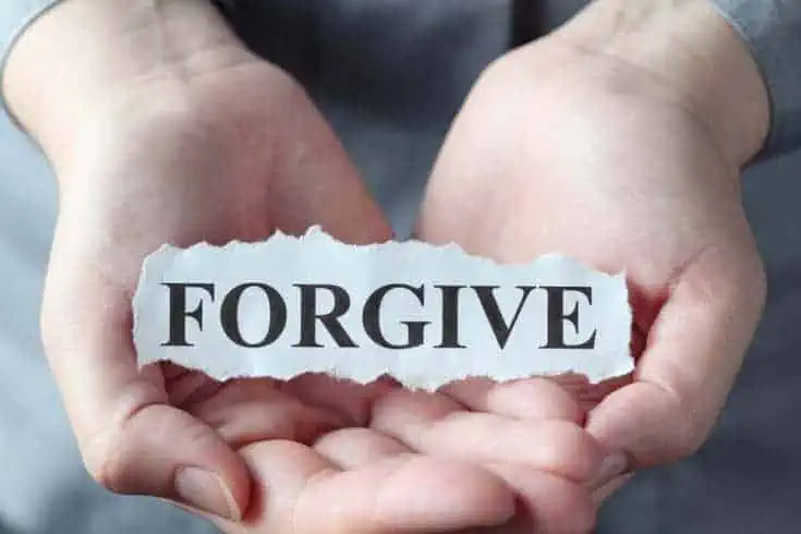 8 Necessities To Build A Great Relationship! 3 a person holding a paper withForgive written on it
