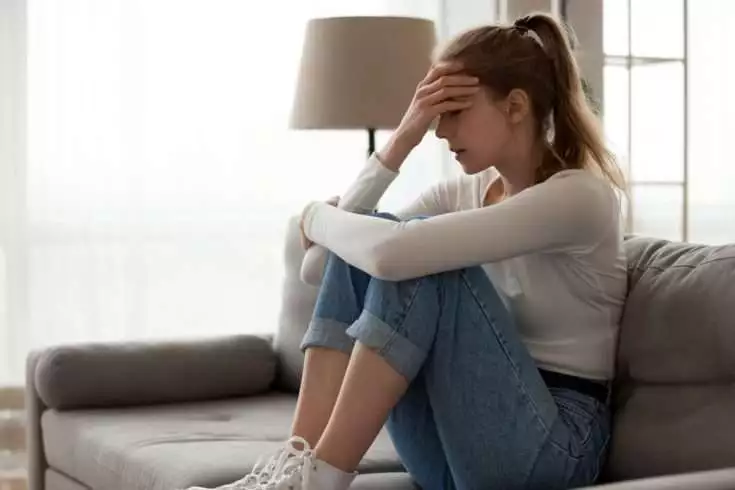 Woman upset and sitting on the floor