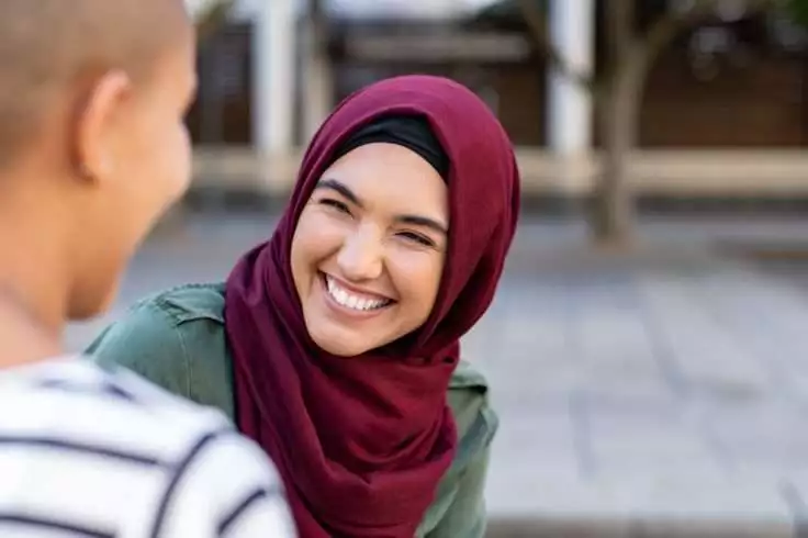 A woman smiling while talking