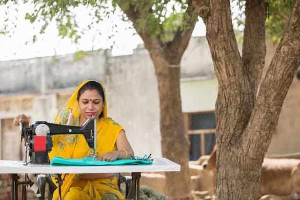 Indian woman sewing clothes.