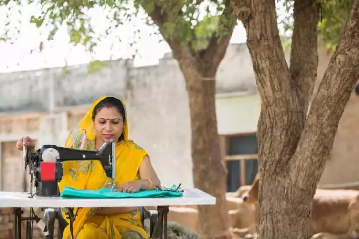 Indian woman sewing clothes.