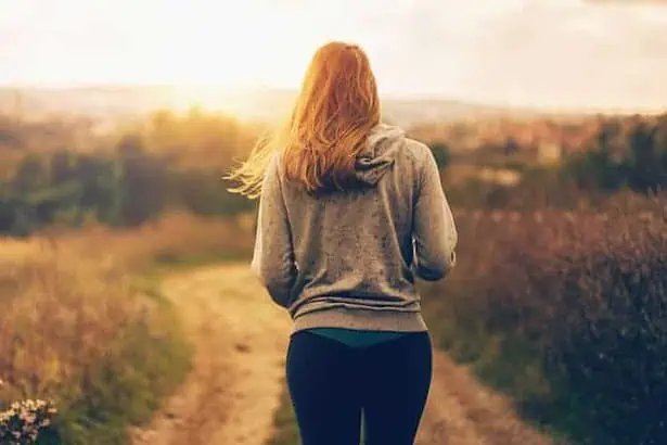 A young woman walking on a path alone