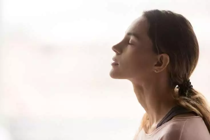 Woman taking a deep breath