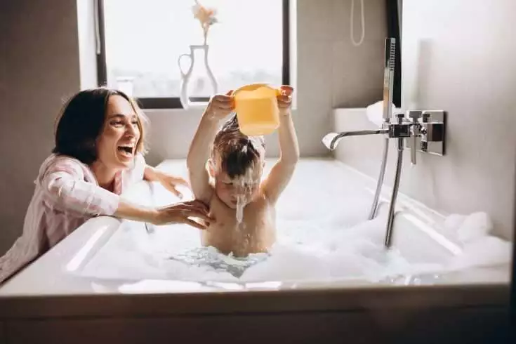 8 Things to Keep in Mind While Introducing A Baby to Swimming 5 Baby playing while taking a bath