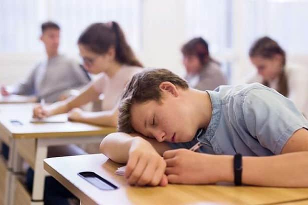 Teenager sleeping in the classroom