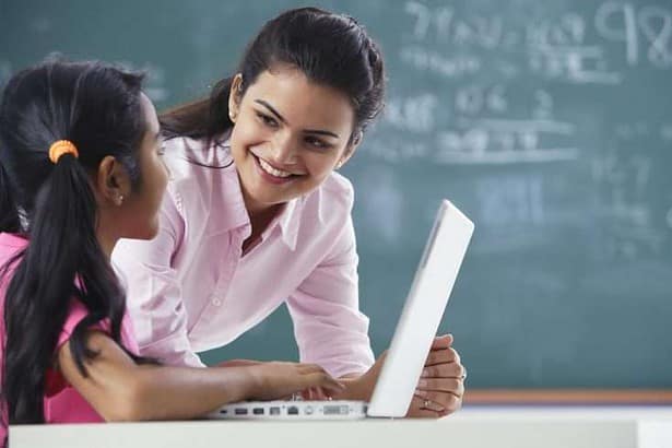 Teacher helping student