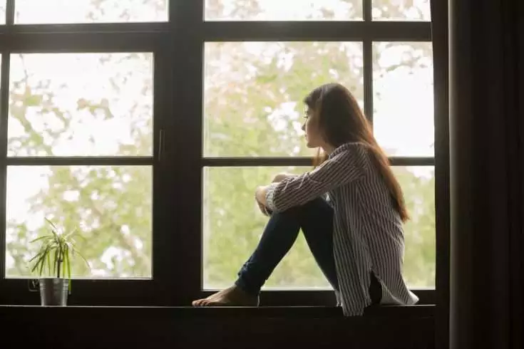 Transformation From An Introvert to An Extrovert 1 Sad woman sitting and looking out of the window