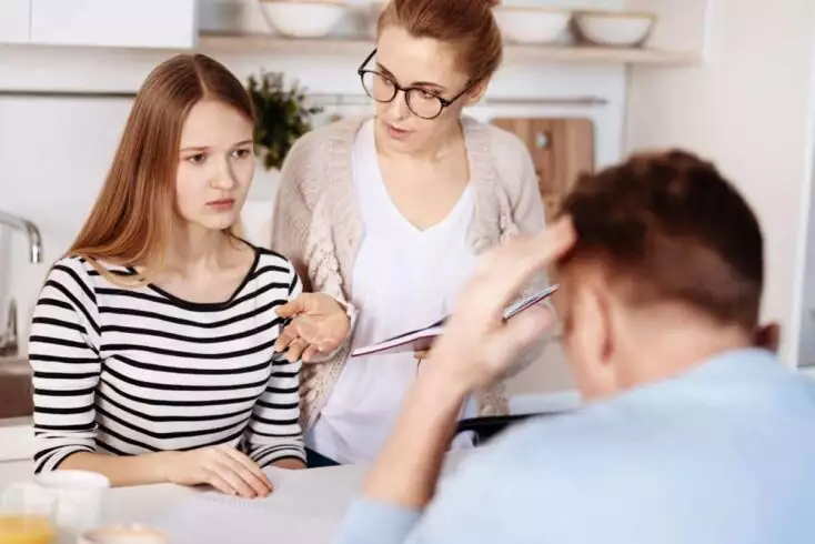 8 Interesting Pros and Cons of Being a Single Child 3 Yous should improve everything. Pleasant strict caring parents sitting at the table with their daughter and scolding her for bad results at school