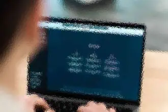 Person holding a tablet displaying digital interface with abstract graphics.