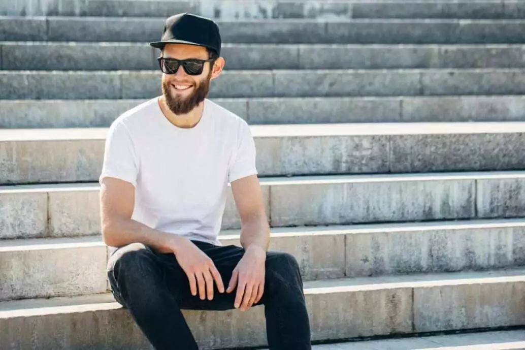 5 Simple Steps to Buy the Best T-Shirts for Men 2 Hipster handsome male model with beard wearing white blank t-shirt with space for your logo or design in casual urban style.