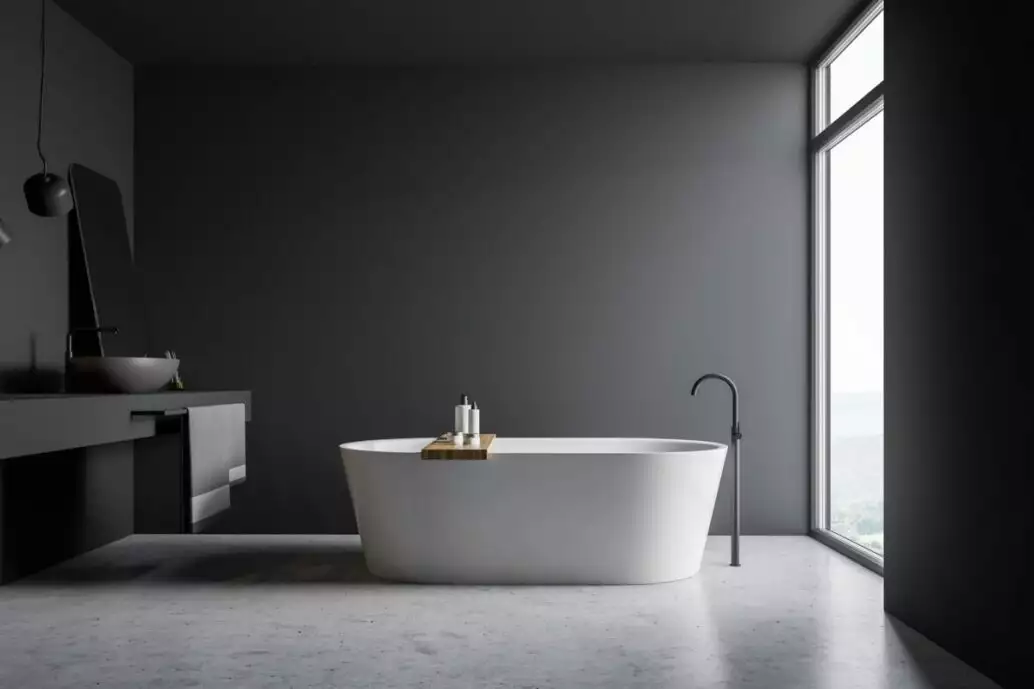 Loo and Behold! - How to Make Your Bathroom Look Gorgeous 2 Interior of loft bathroom with gray walls, comfortable bathtub and gray sink with mirror standing on gray countertop. 3d rendering.