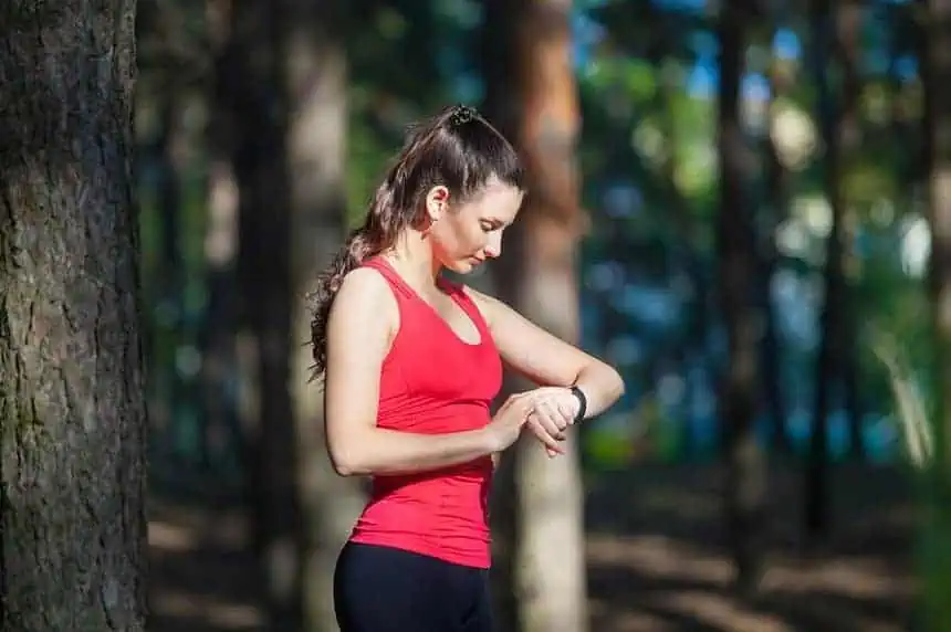 Top 8 Useful Applications You Should Try Out Today! 1 Beautiful woman runner looks at her fitness tracker getting ready for a run in the summer forest. Source: Depsoitphotos