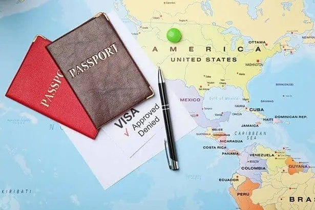 Passports and pen on map. Approved American visa.