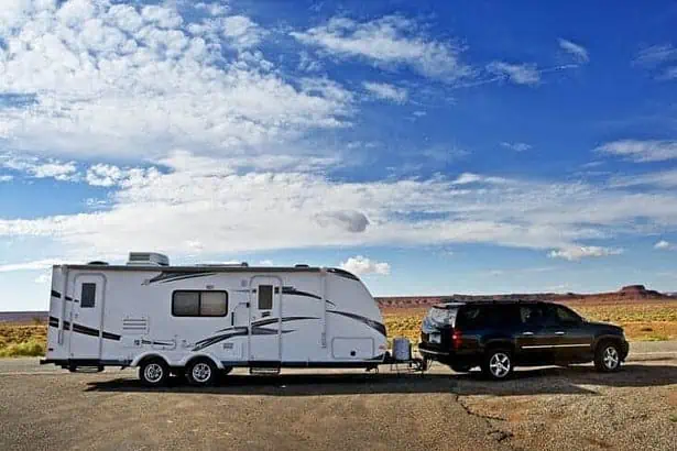 RV Trailer Journey. Travel Trailer Pulling by Large Sport Utility Vehicle in Arizona USA. RV Adventures. Recreation Photo Collection.