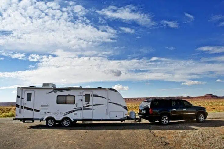 RV Trailer Journey. Travel Trailer Pulling by Large Sport Utility Vehicle in Arizona USA. RV Adventures. Recreation Photo Collection.