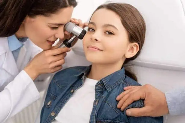 Physician inspecting a girl.