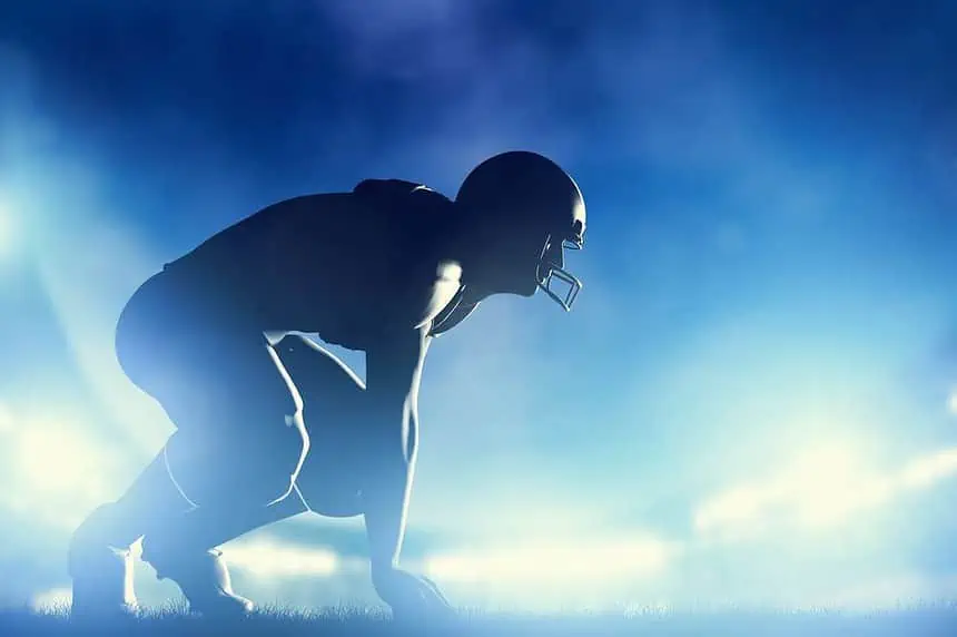 American football player in game. Night stadium lights.