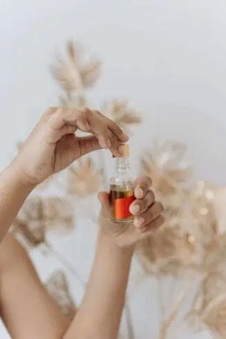 Does Tea Tree Oil Help with Acne? 101 Genuine Ways 11 person-holding-clear-glass-bottle