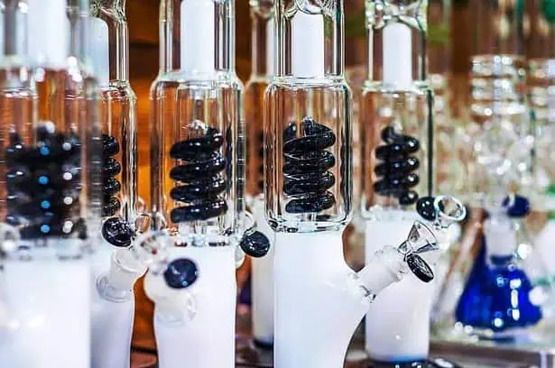 white bongs with black spiral percolator on blurred background.