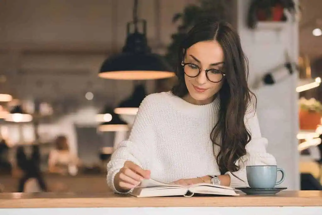Woman reading a coffee table book. 