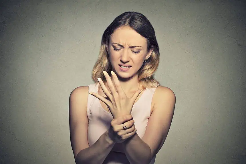 How to Use Gels & Creams to Help You Deal With Neuropathy 1 Woman holding wrist that is paining.