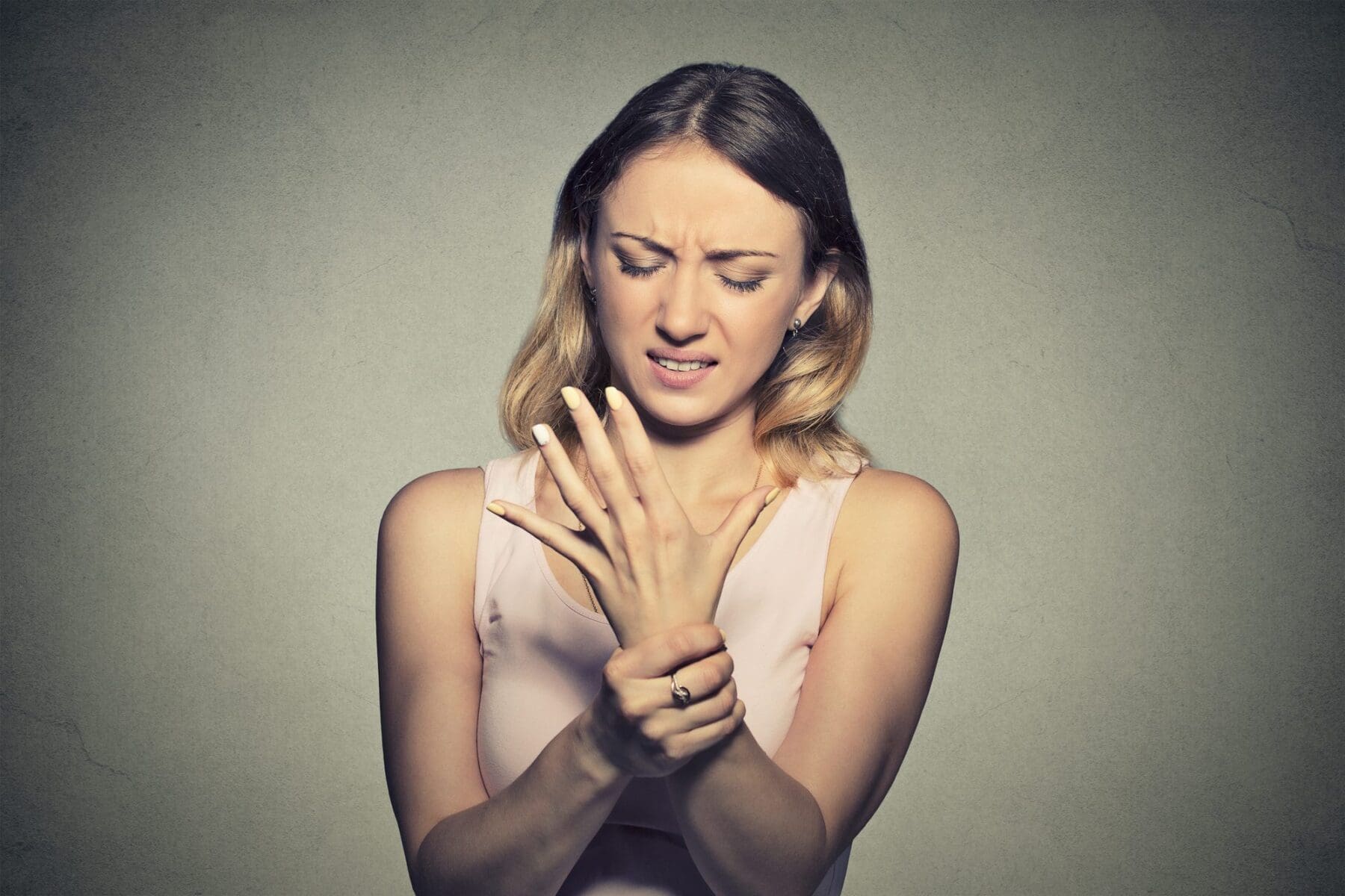 Woman holding wrist that is paining.