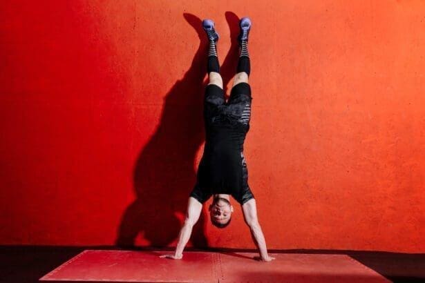 Athlete doing push ups on his hands while standing upside down