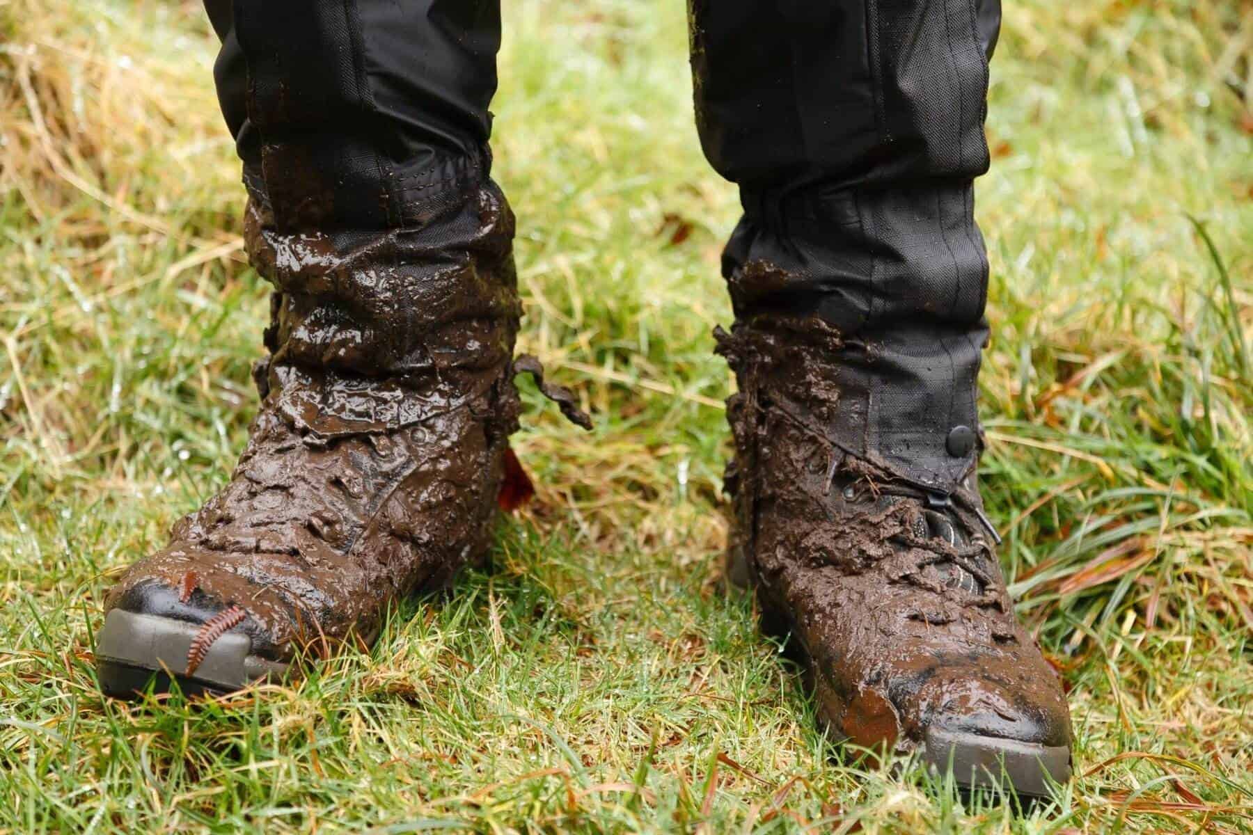 Muddy hiking boots and waterproof gaiters