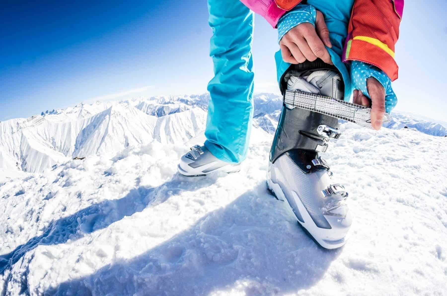 Female skier fastening her boots
