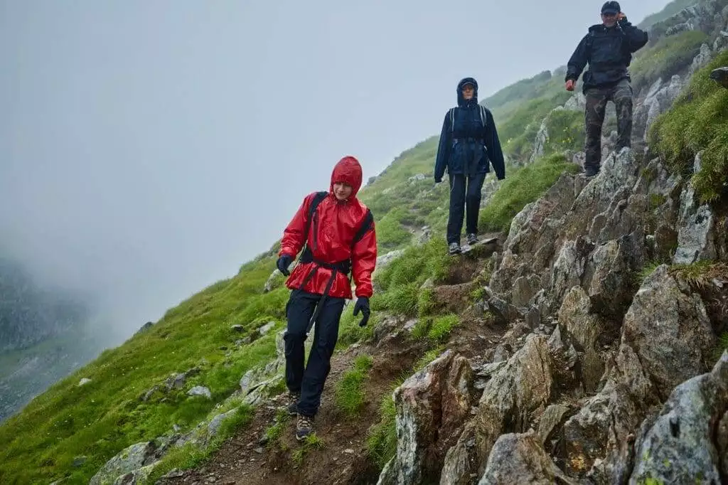 How Long Should You Wait Before Hiking After Rain? 3 Hikers in raincoats on mountain