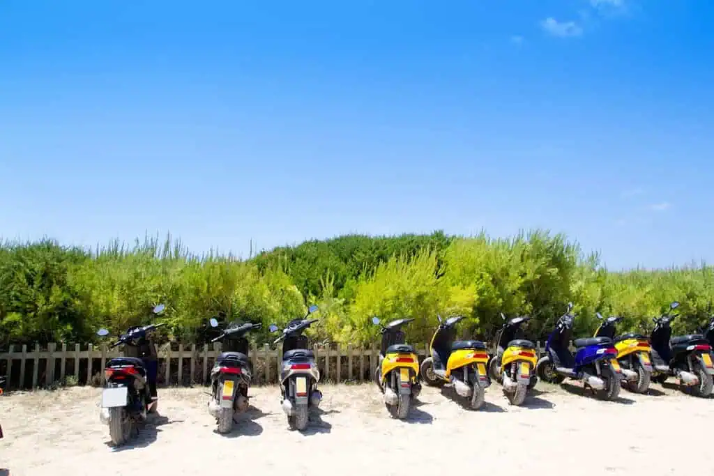 Scooters parked on a empty road