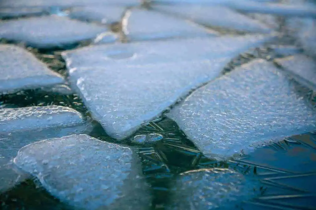 At What Temperature Does Water Freeze: Unknown Facts 7 Water Droplets on Blue Surface
