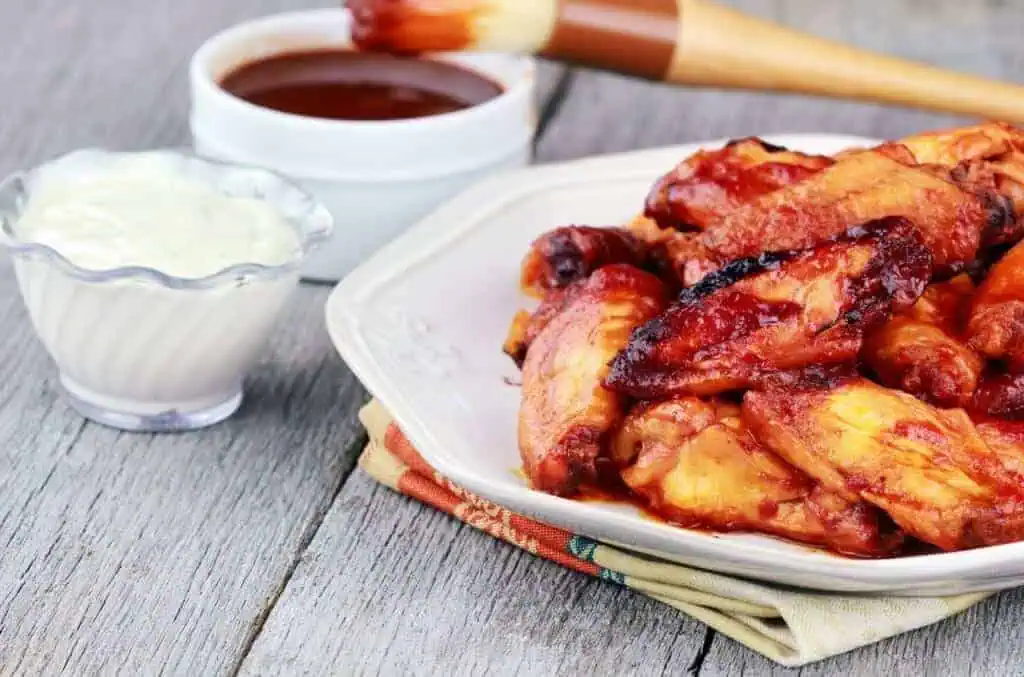 The Ultimate Chicken Wings Companion: 13 Mouth-Watering Side Dishes 3 Chicken wings served on the table